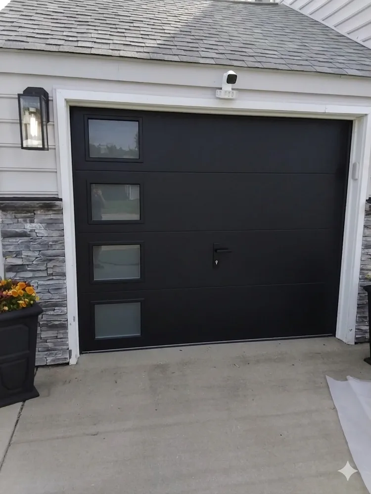New black flush panel garage door after installation