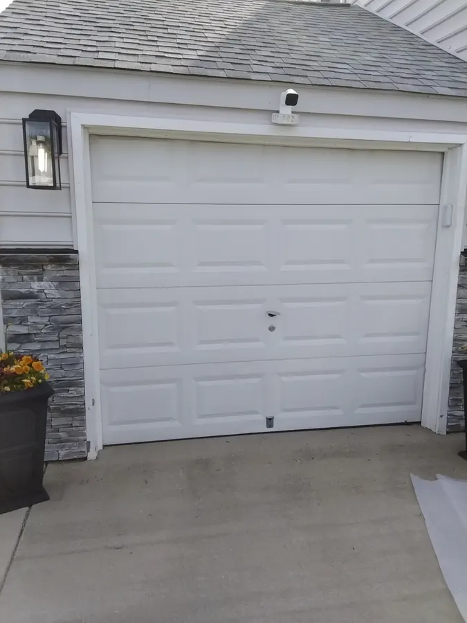 Old white garage door before replacement